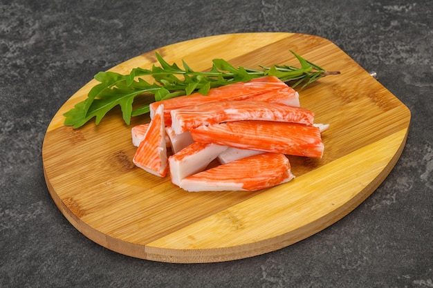 Crab stick surimi over wooden board