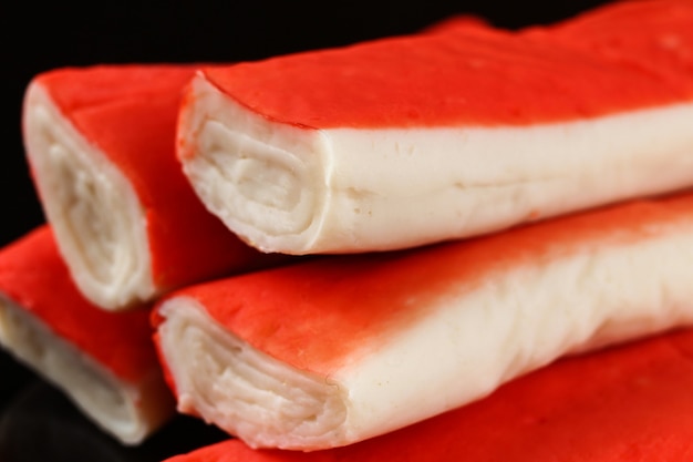 Crab sticks on a black surface