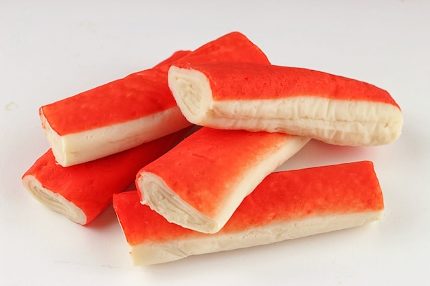 Crab sticks on a white surface