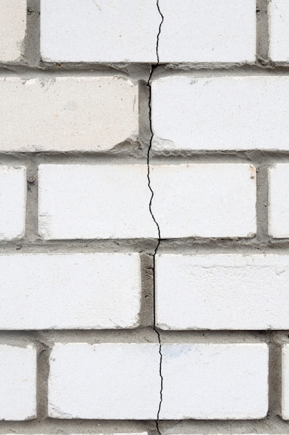 Photo the crack in the brick wall. stone