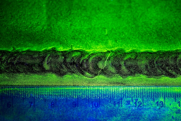 Crack steel butt weld carbon background green contrast of magnetic