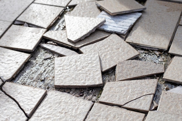 Cracked brown tiles on cement floor