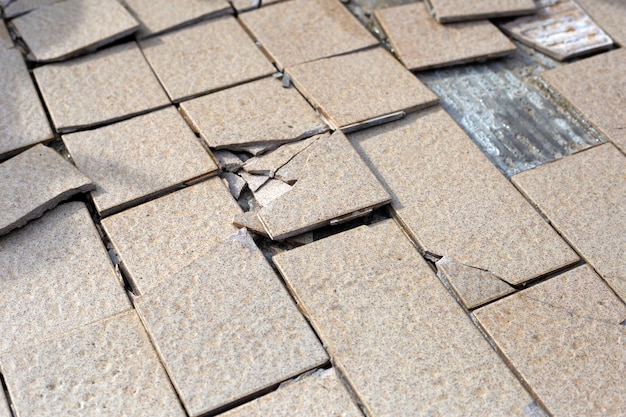 Cracked brown tiles on cement floor