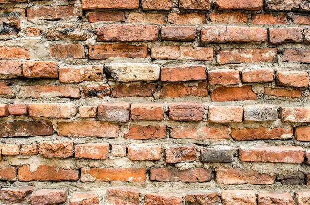 Photo cracked concrete vintage brick wall background