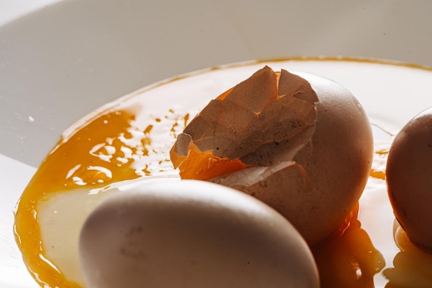 Cracked eggs on white plate with morning light brocken eggshell