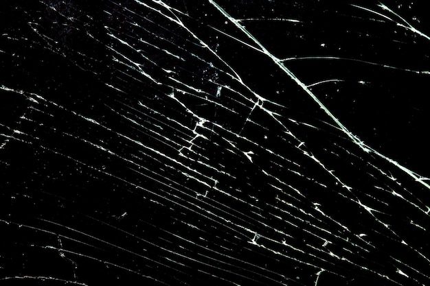 Cracked glass isolated on a black background. broken glass