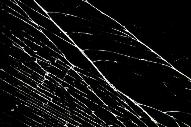 Cracked glass isolated on a black background. broken glass