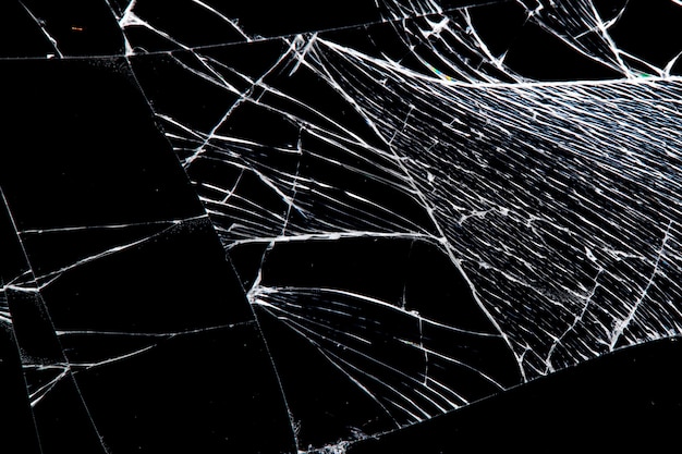 Cracked glass isolated on a black background. broken