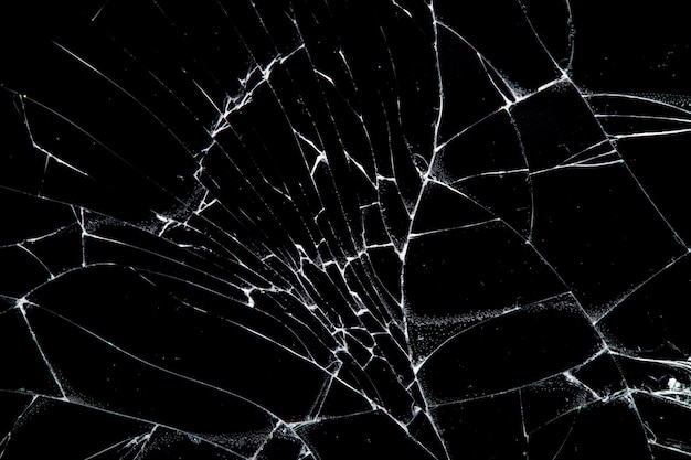 Photo cracked glass isolated on a black background. broken