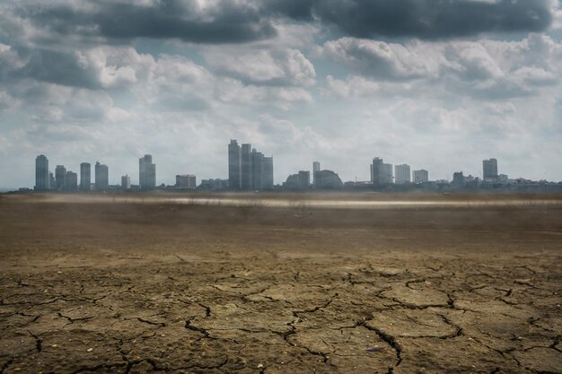 Photo cracked land against cityscape