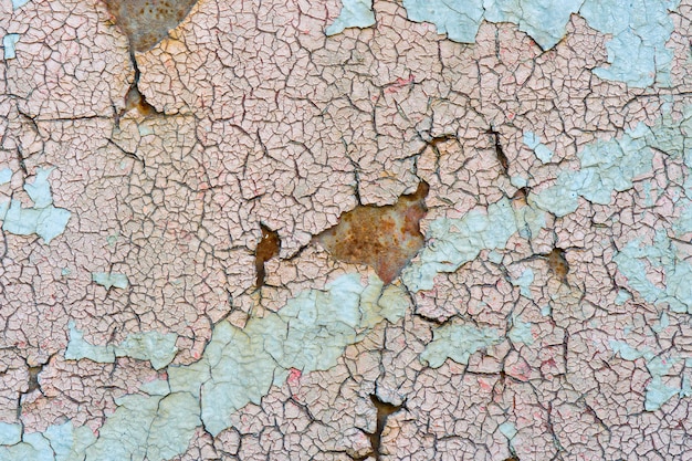 Cracked paint on rusty metal.