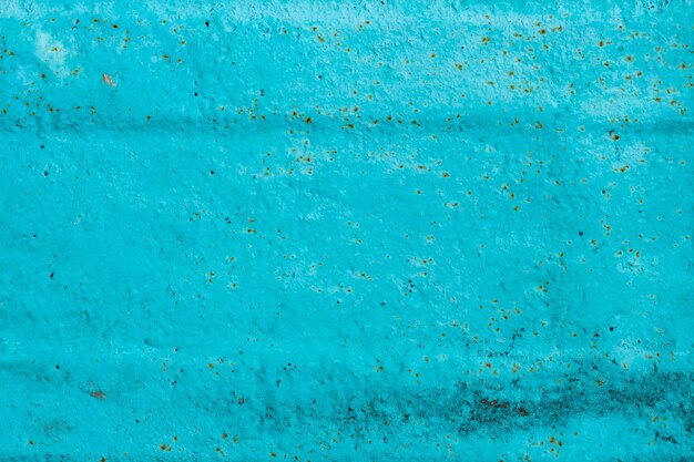 Cracked painted old metal texture. Abstract background of painted turquoise surface. Grunge blue wall background