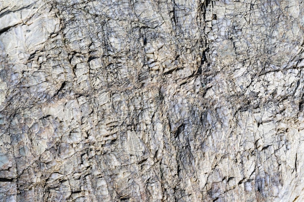 Cracked stone surface grey color Detailed nature background or pattern texture