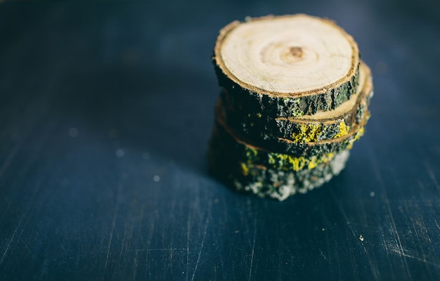 Cracked wooden tree section with rings and texture isolated on dark. Wooden round empty cutting board. Top view of a tree stump