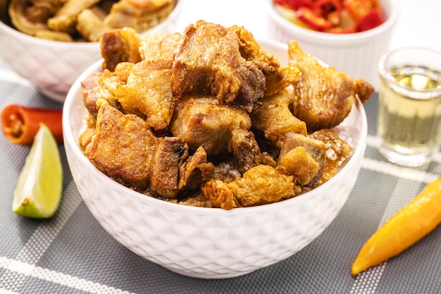 Crackling bowl Brazilian appetizer made by frying bacon leather or meat and lots of fat taken from the pork belly