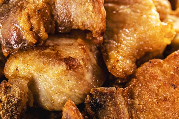 Crackling bowl Brazilian appetizer made by frying bacon leather or meat and lots of fat taken from the pork belly
