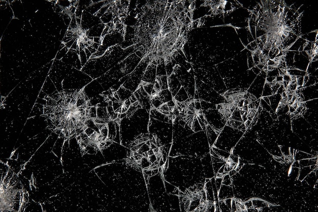 Photo cracks on black glass background, broken abstract glass hole destruction concept