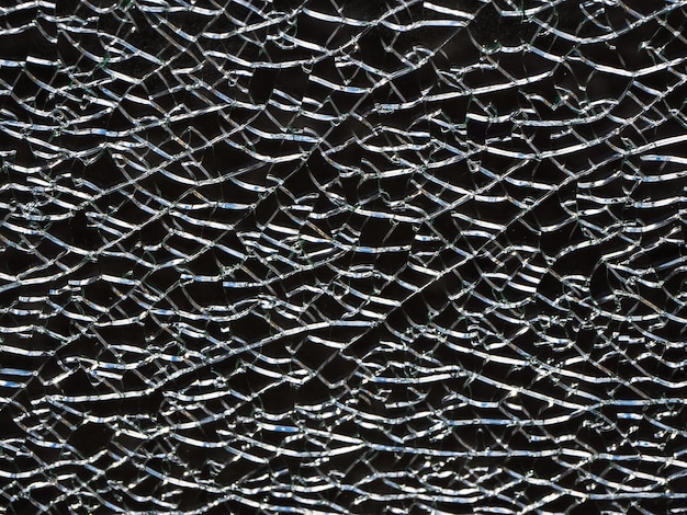 cracks in the glass. black abstract background with cracks.