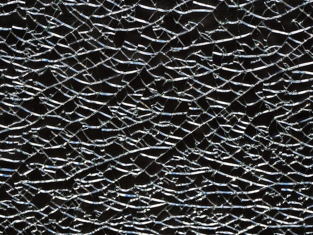 Cracks in the glass. Black abstract background with cracks.