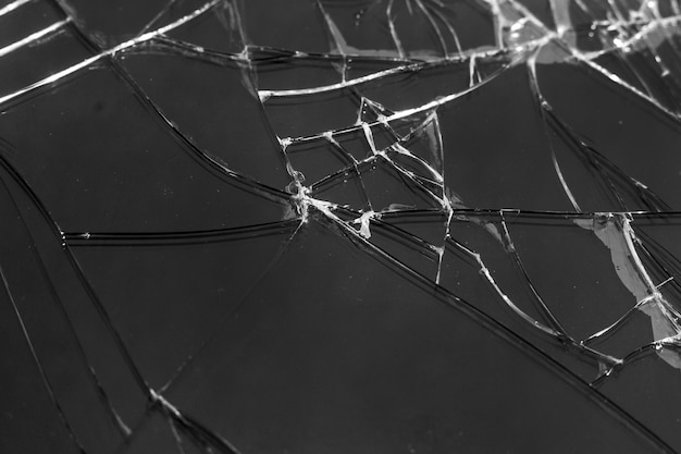 Cracks on glass, screen of broken mobile phone. The phone needs repair_