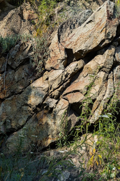 Cracks in the granite rock due to human activity. Destruction of the granite rock of the mountain after the explosion. Concept of environmental problems