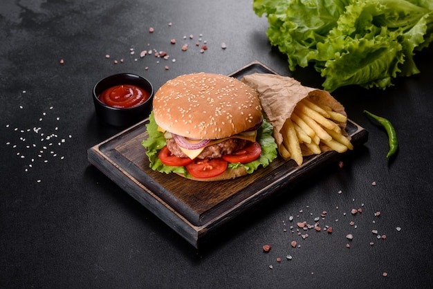 Craft beef burger and french fries on a black background