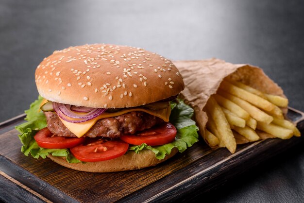 Craft beef burger and french fries on a black background