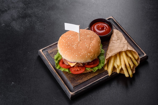 Craft beef burger and french fries on a black background