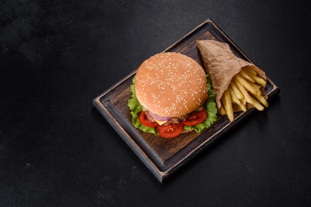 Craft beef burger and french fries on a black background