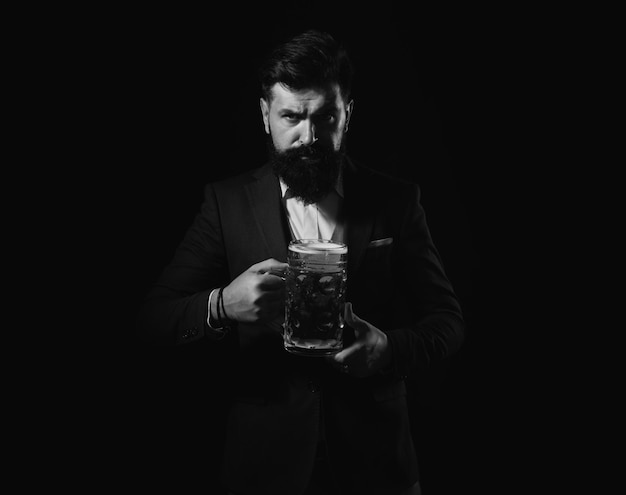 Craft beer confident man with glass of beer on black