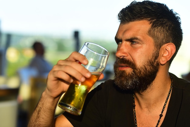 Craft beer confident man with glass of beer degustation and
tasting beer pub and bar