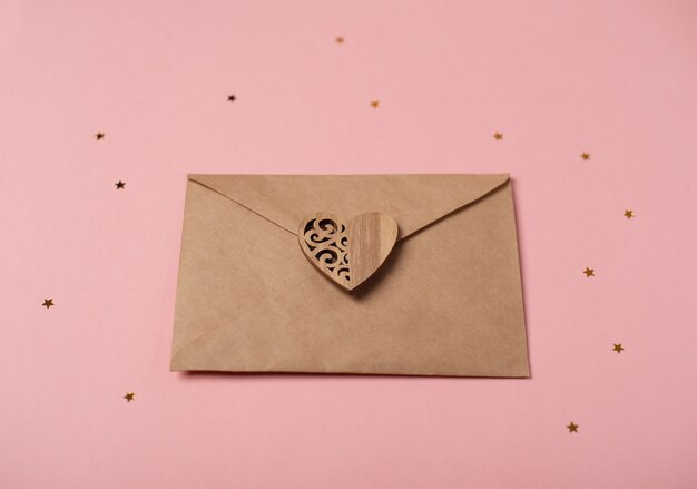 Craft envelope with the wooden heart with little stars.\
romantic love letter for valentine\'s day concept.