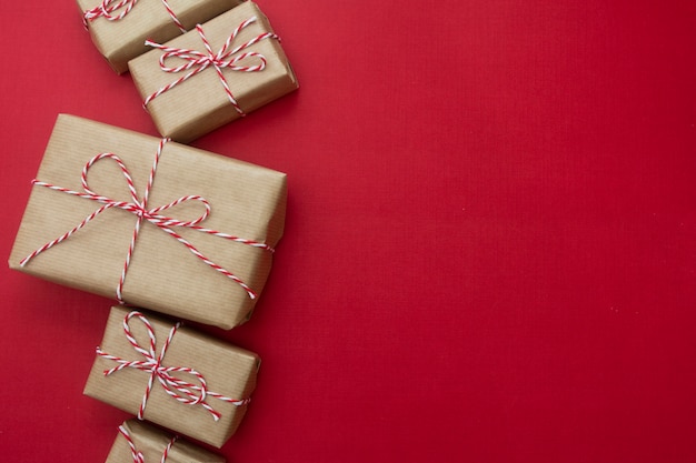 Craft gift boxes over red background. christmas mock up with copy space.