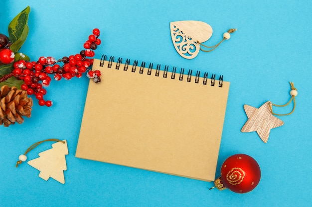 Craft notebook on a blue background glasses and Christmas toys