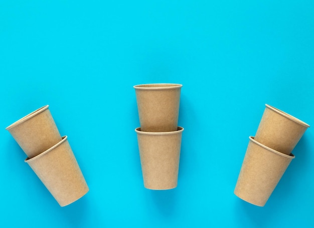 Craft paper cups on blue background Eco friendly