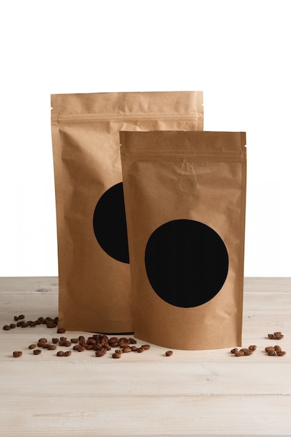 craft paper pouch bags with coffee on wooden table