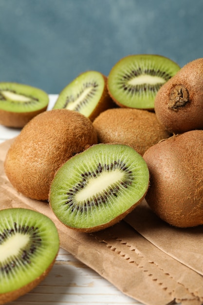 Craft paper with kiwi on wooden table