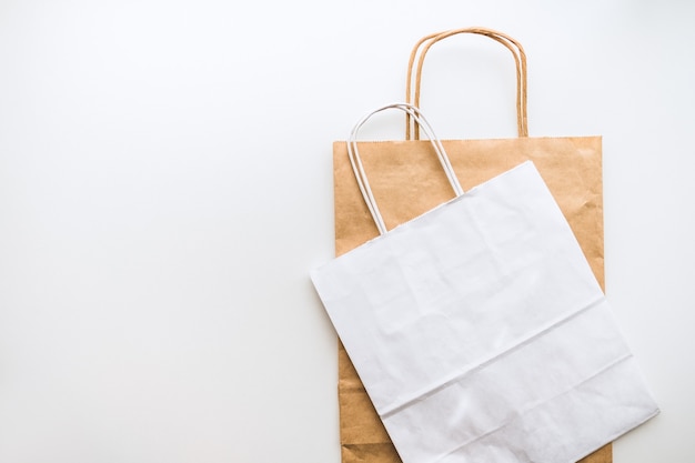 Craft and white eco-friendly paper bags isolated