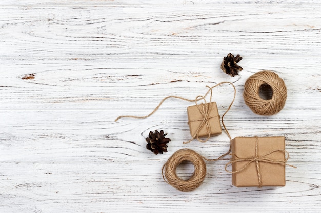 Crafted gift on rustic wooden background with Christmas decoration