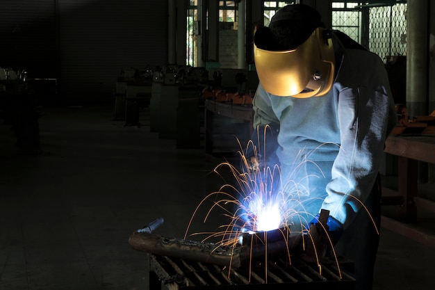 A craftman is welding with workpiece steel