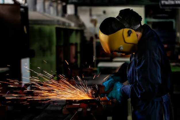 A craftman is welding with workpiece steel.