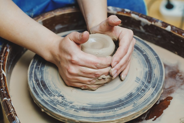 Craftsman artist shapes pot