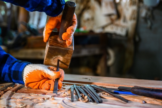 craftsman carved wood craftsmen use wooden hammers to shovel wood chisels tools carpentry work wooden background Engineers provide tree shapes.