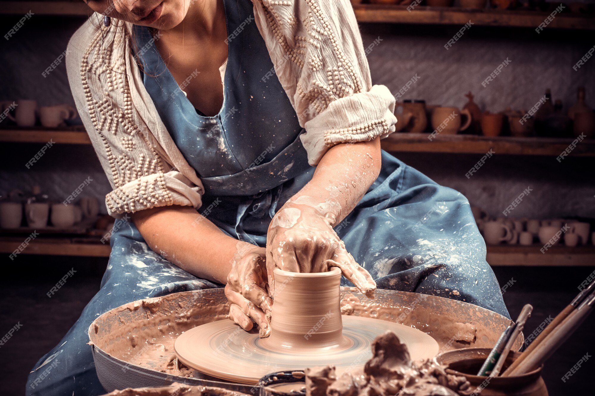 Premium Photo  Freshly made clay pot on a potters wheel