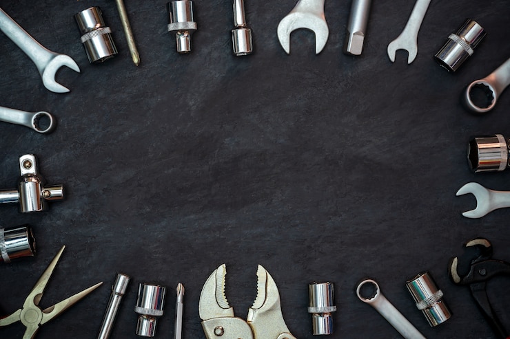 Photo craftsman tool on black cement background. copyspace. concept of maintenance to be reused as before.