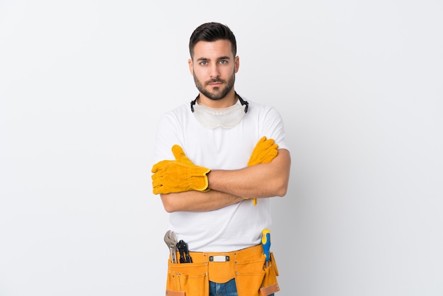 Craftsmen or electrician man over isolated white wall keeping arms crossed