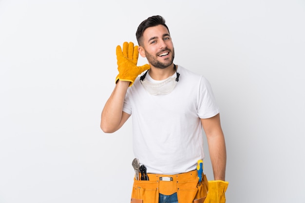 Craftsmen or electrician man over isolated white wall listening something