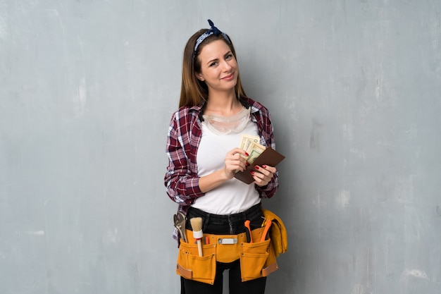 Craftsmen or electrician woman holding a wallet