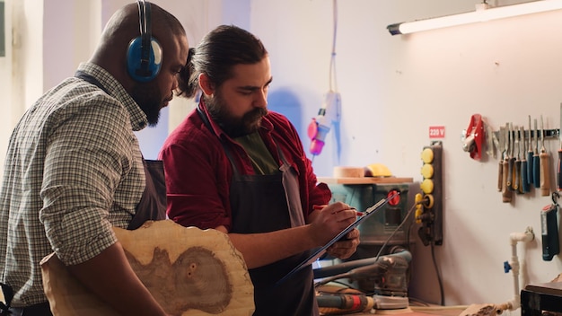 Craftsperson and woodworker looking over technical schematics