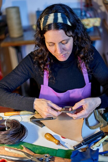 Craftswoman working leather